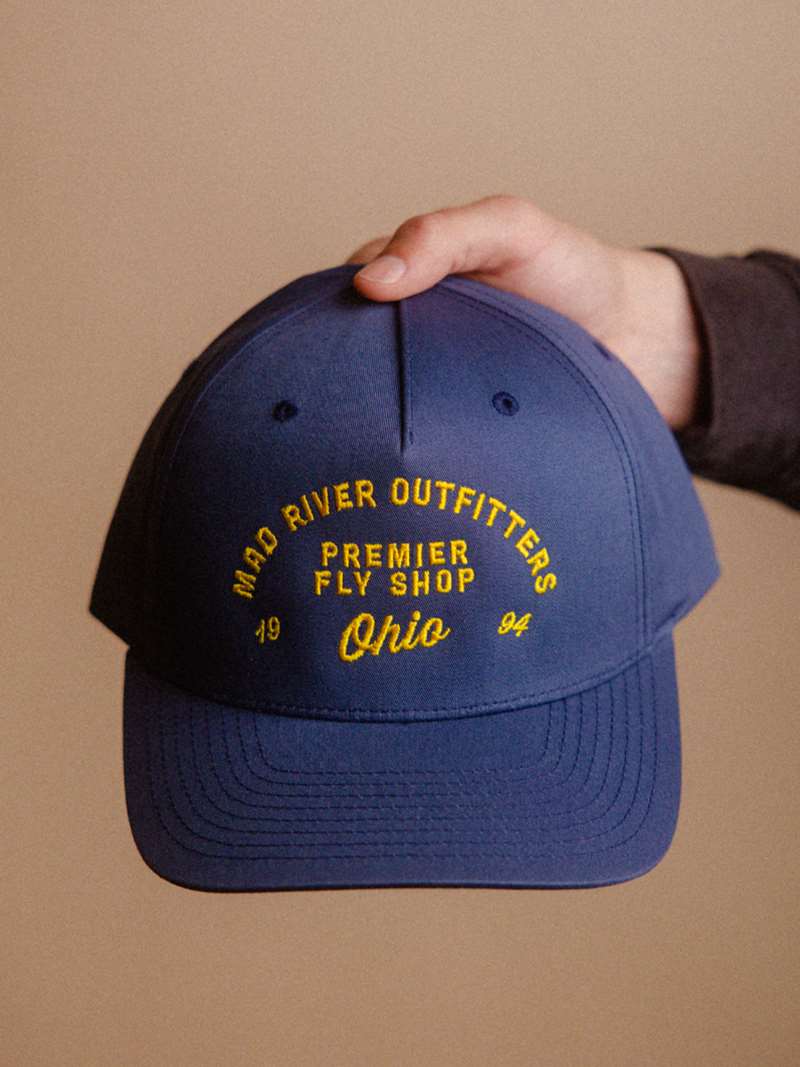The Mad River Outfitters Pinch Front Hat features the new for 2026 "MRO Premier" Logo.