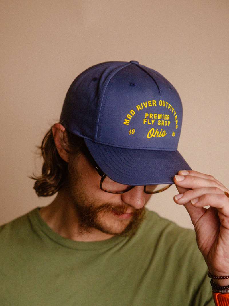 The Mad River Outfitters Pinch Front Hat features the new for 2026 "MRO Premier" Logo.